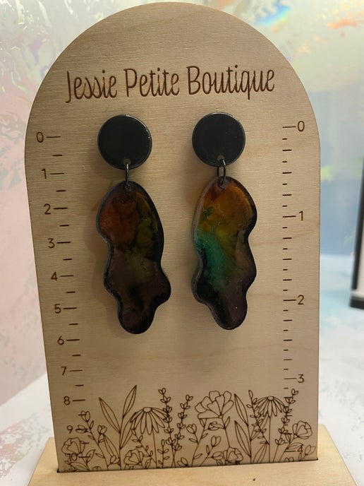 Pair of earrings on a wooden display card with 'Jessie Petite Boutique' branding.