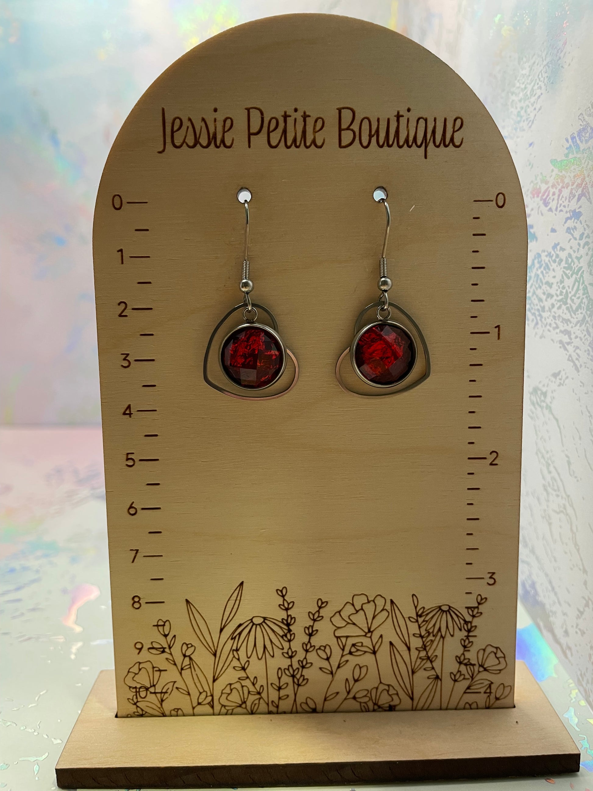 Pair of earrings on a 'Jessie Petite Boutique' card with floral design
