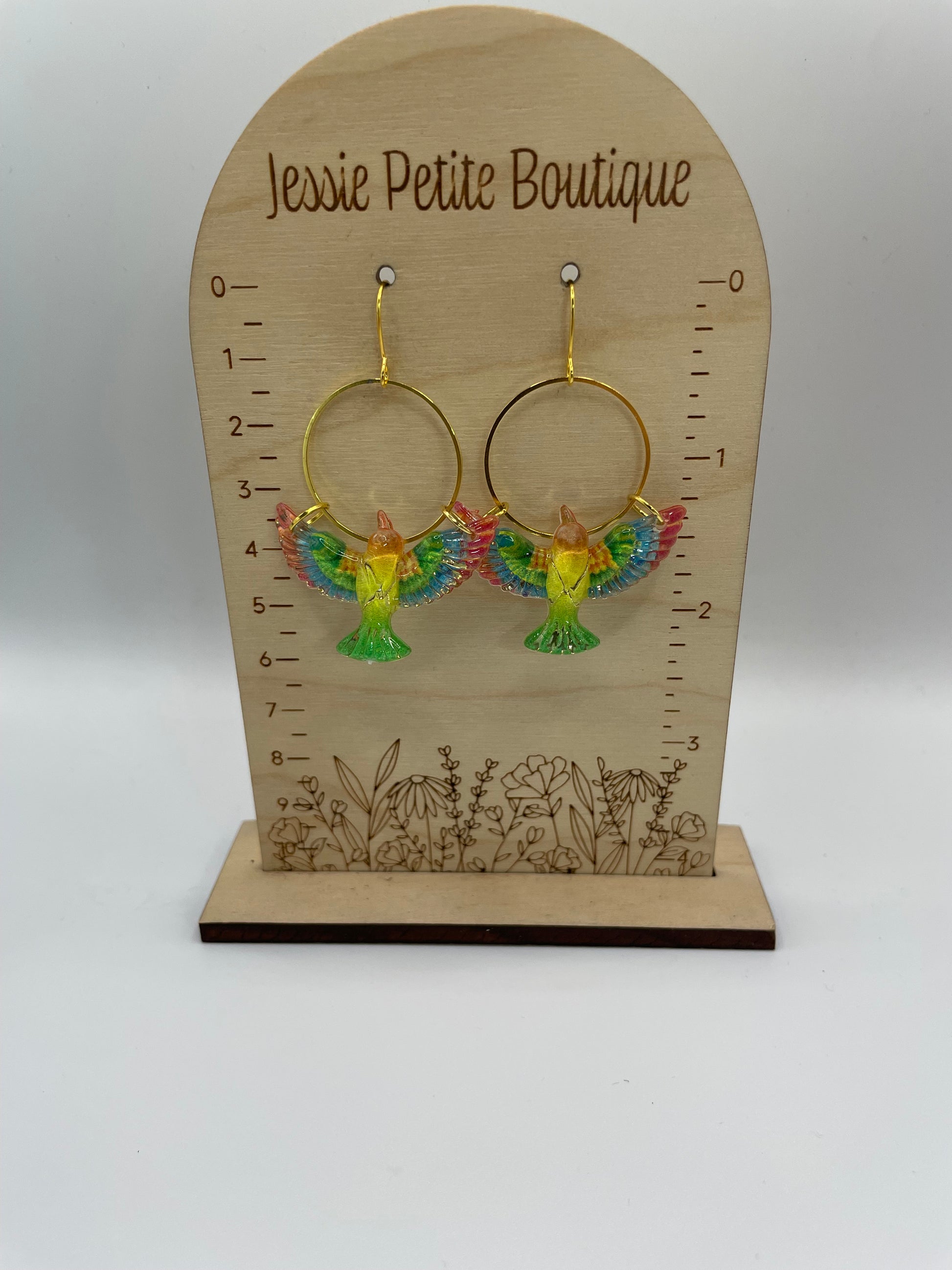 Jewelry display card with colorful earrings on a white background