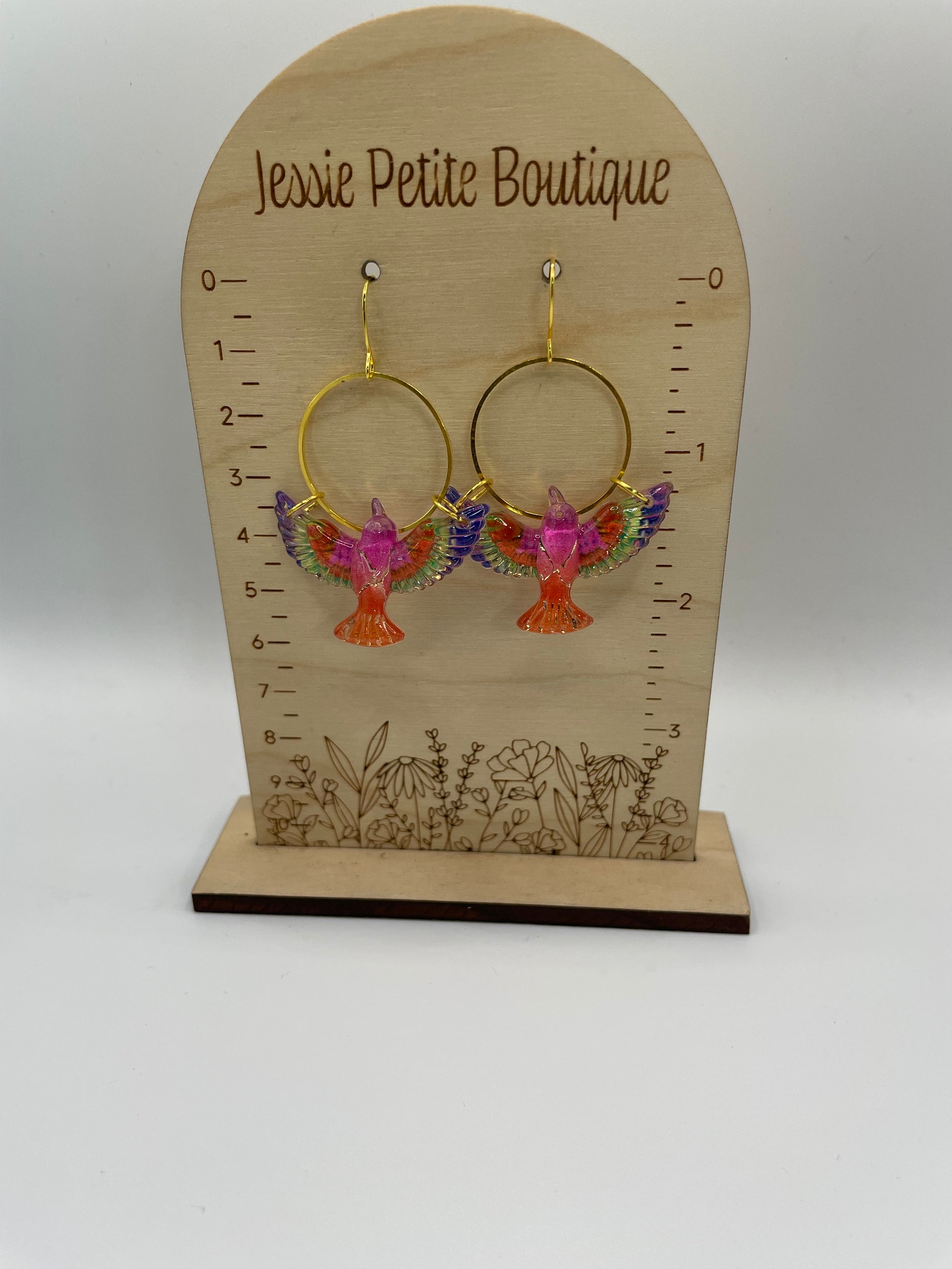 Earring display card with floral hoop earrings on a white background