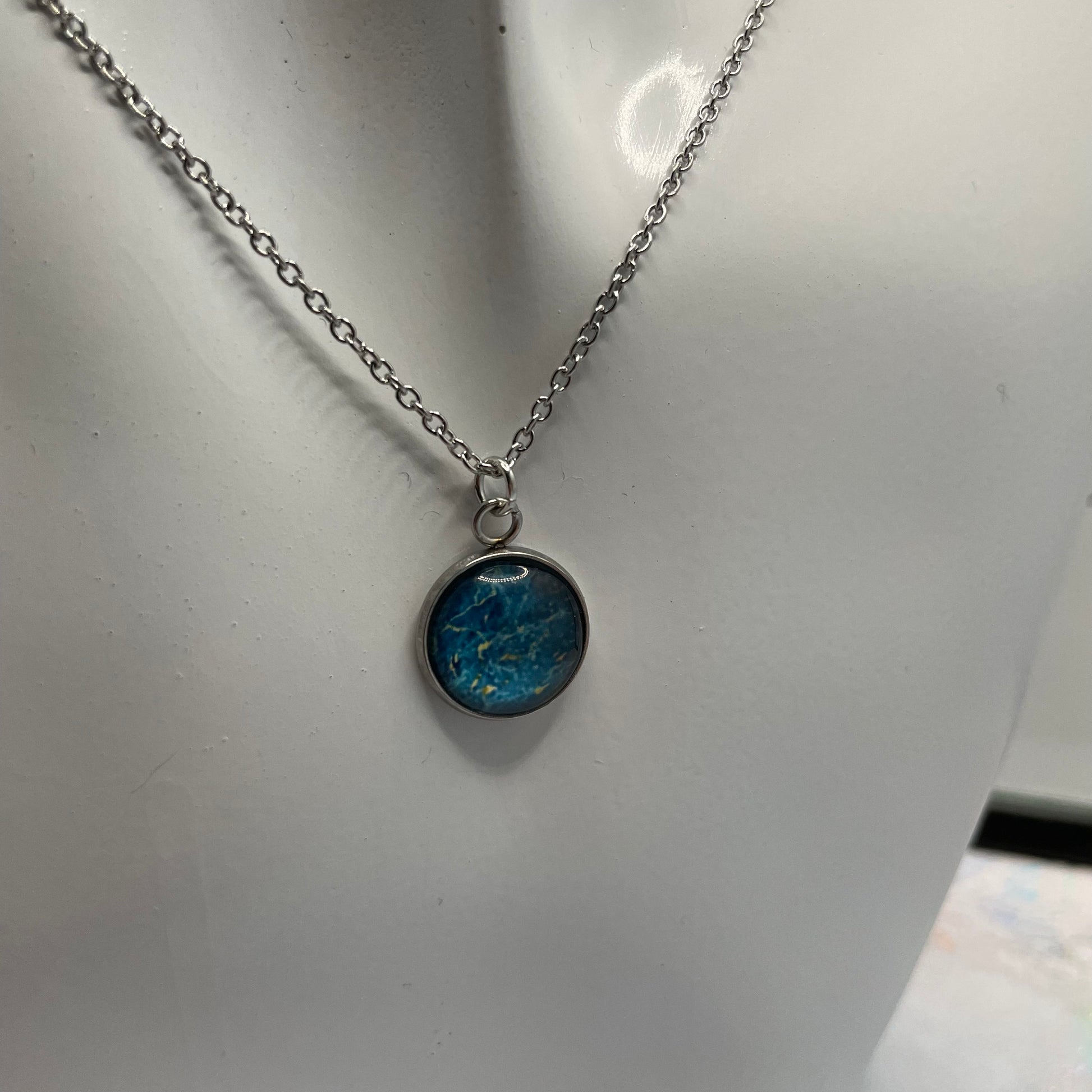 Necklace with a blue pendant on a white background