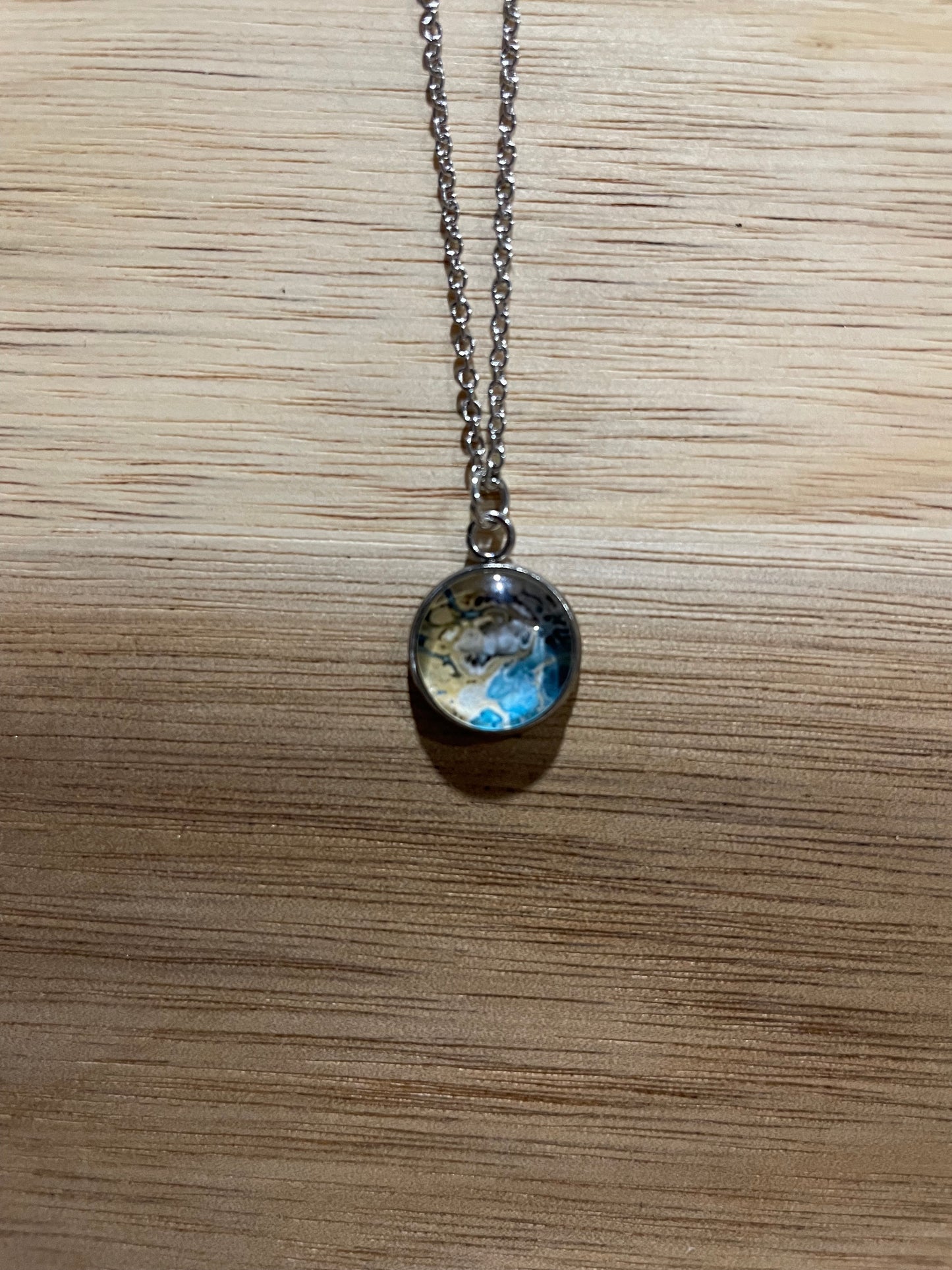 Necklace with a round pendant on a wooden surface