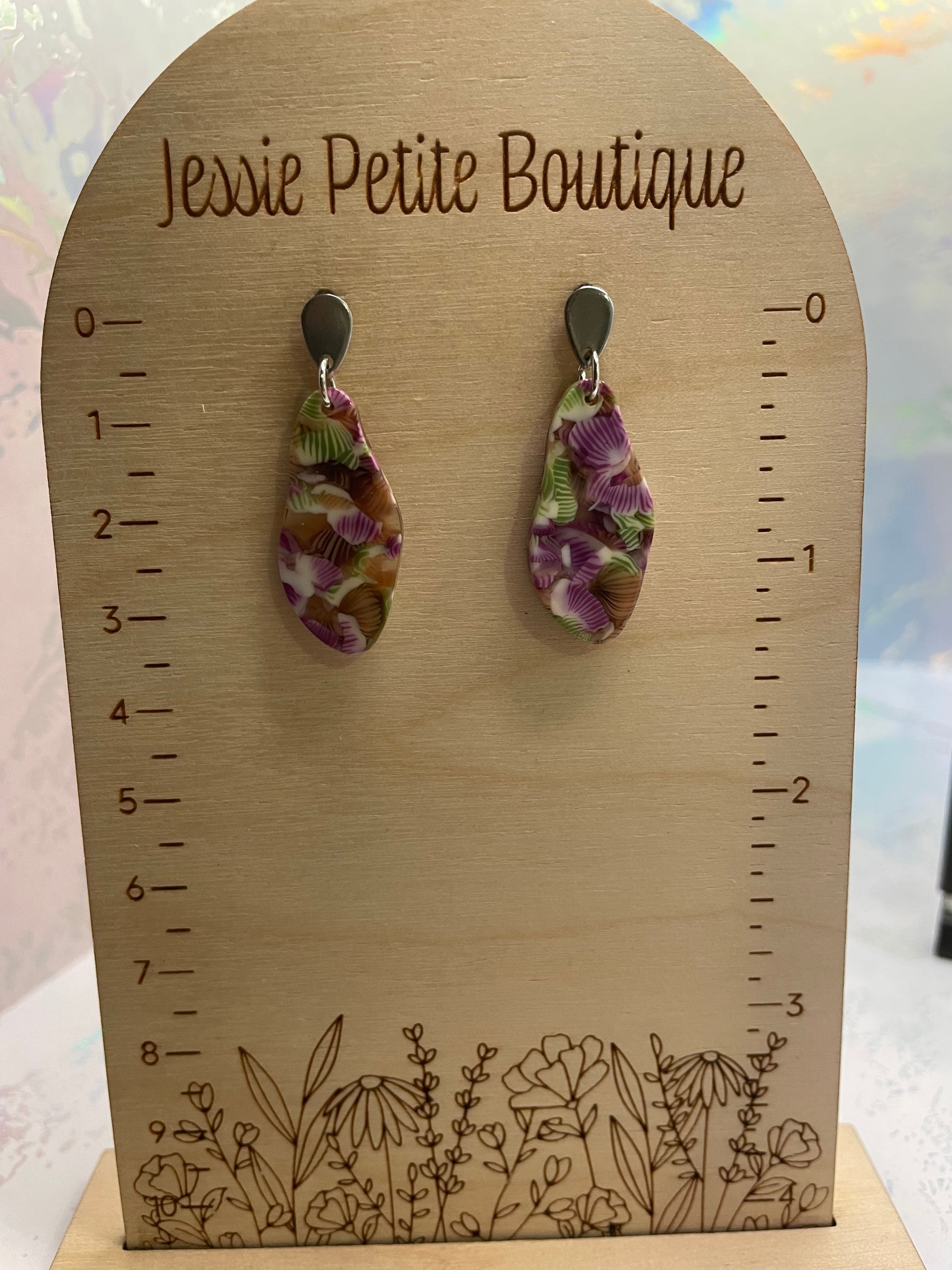 Pair of teardrop earrings on a wooden card with measurements and 'Jessie Petite Boutique' branding.