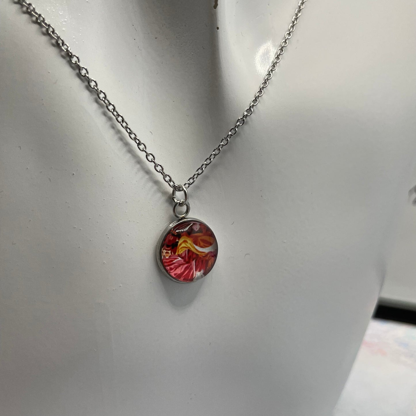 Necklace with a colorful pendant on a white surface