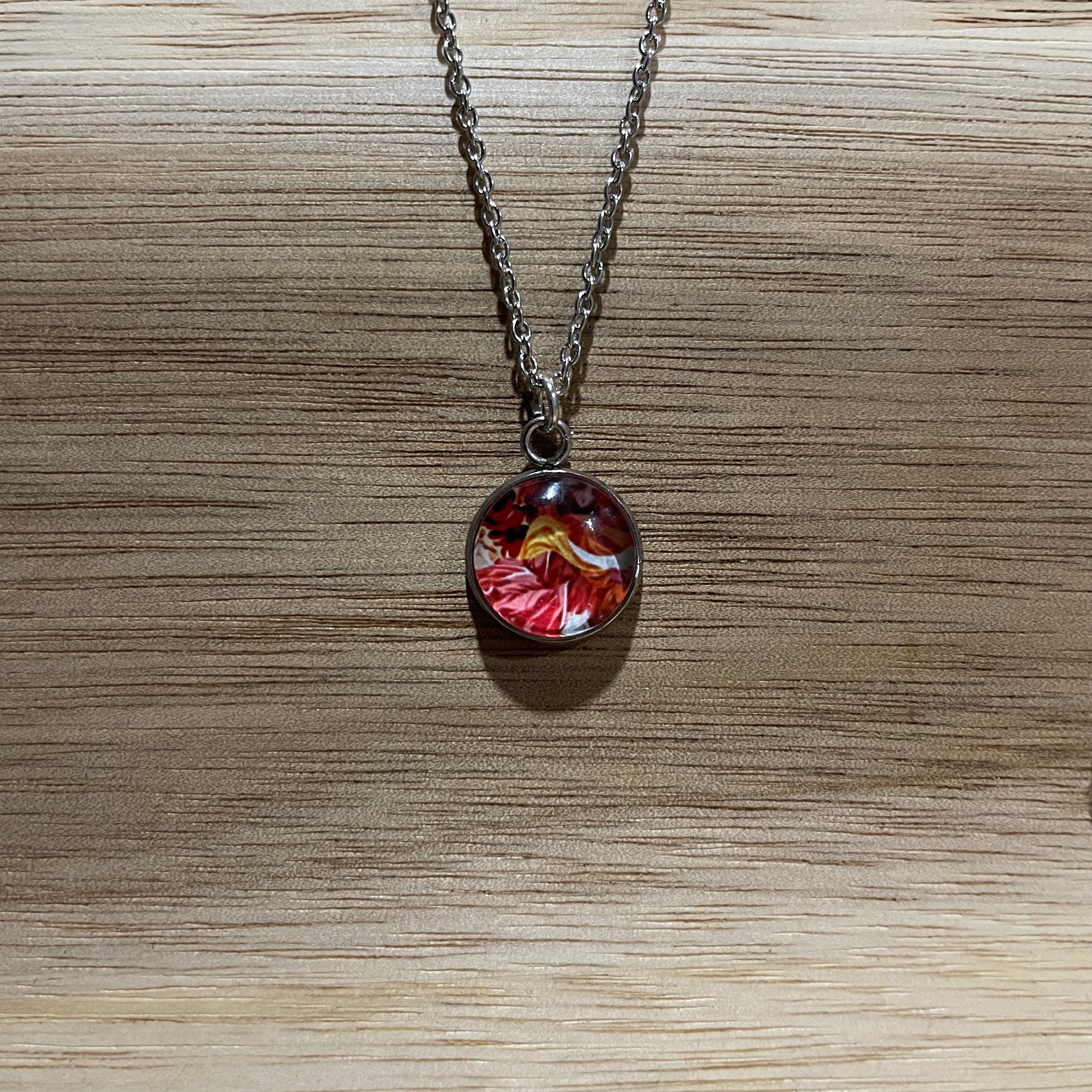 Necklace with a floral pendant on a wooden surface