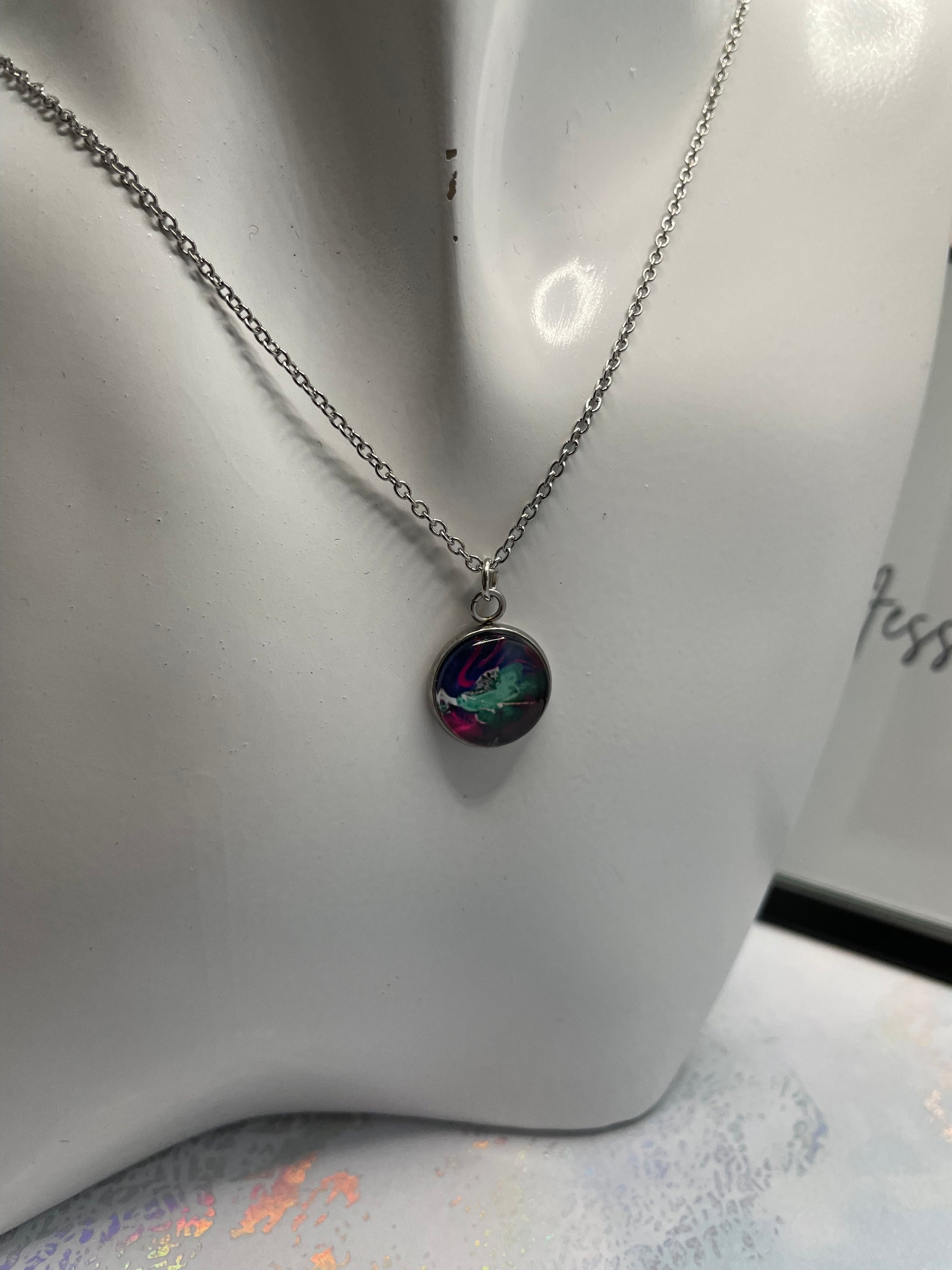 Necklace with a colorful pendant on a white surface