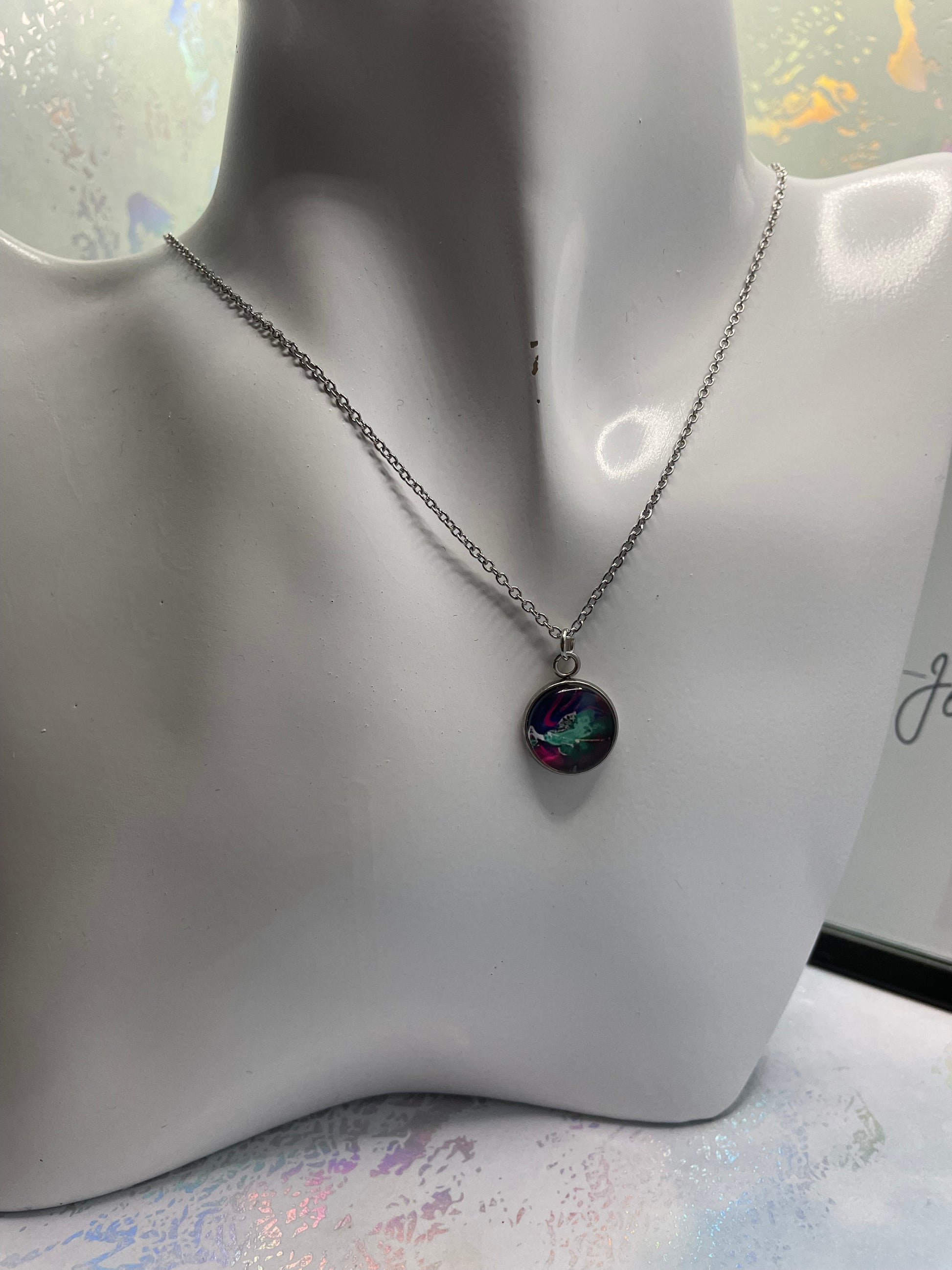 Necklace with a colorful pendant on a mannequin bust