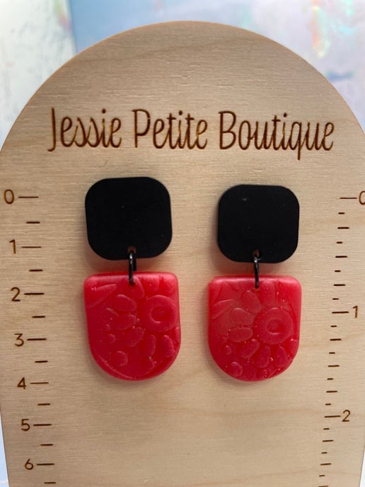pink and black earrings on a wooden display card with 'Jessie Petite Boutique' branding.