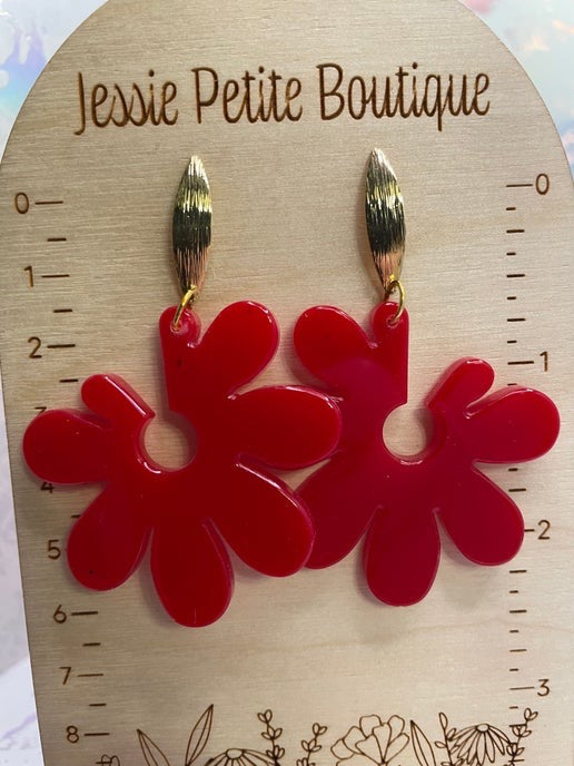 Red floral earrings on a wooden card with 'Jessie Petite Boutique' branding.