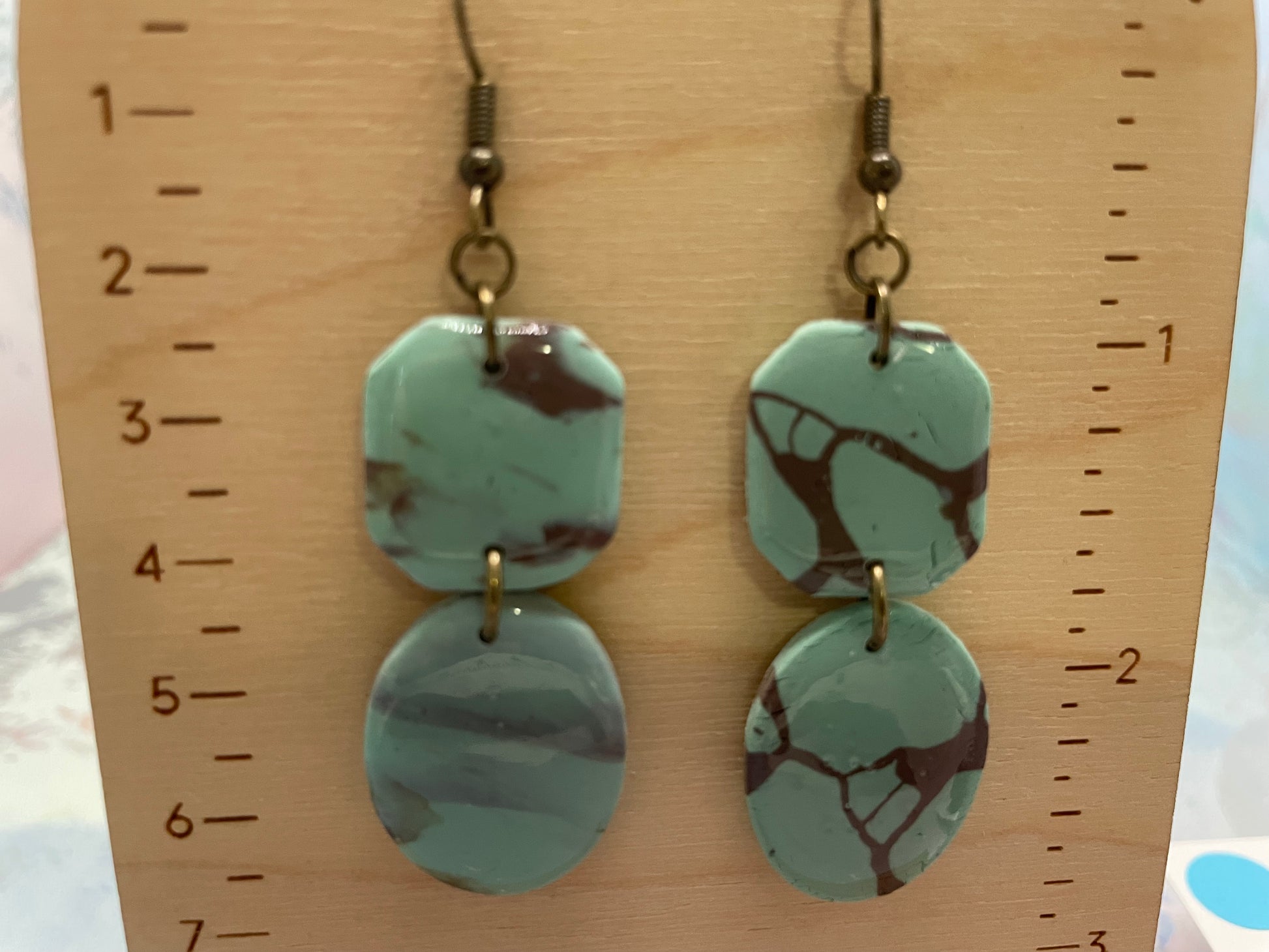 shayna earrings on a wooden ruler