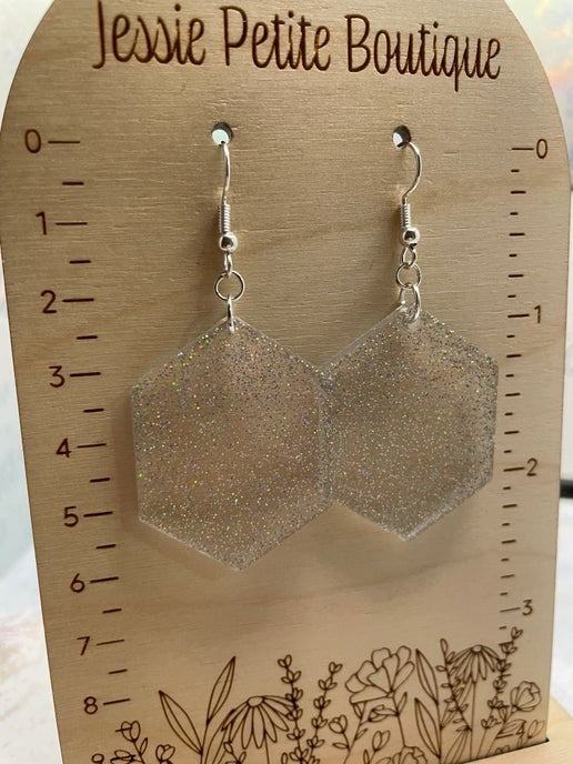 Hexagonal earrings on a wooden card with 'Jessie Petite Boutique' branding.