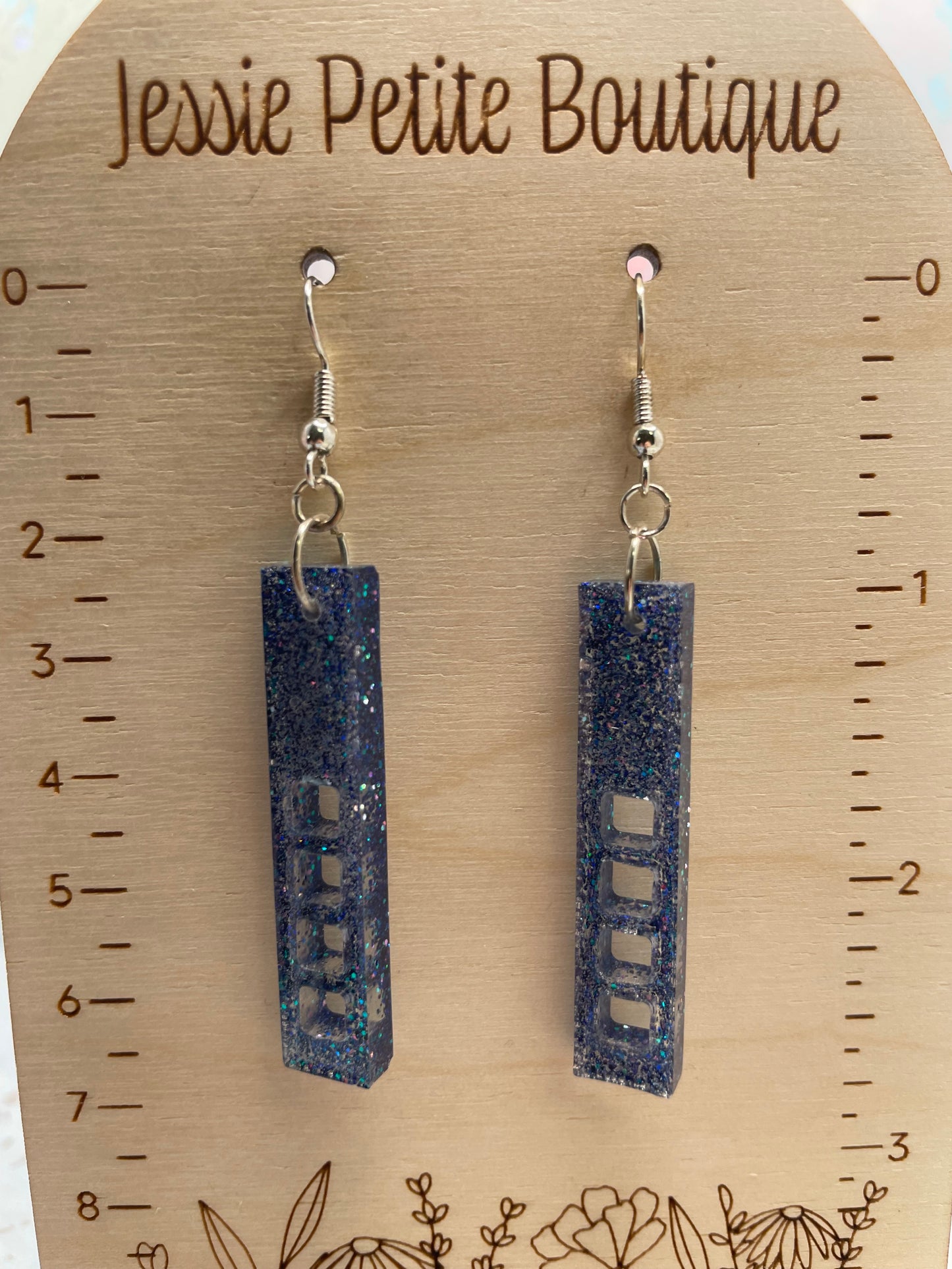 sparkly purple:skyscraper earrings on a wooden display card with measurements and 'Jessie Petite Boutique' branding.