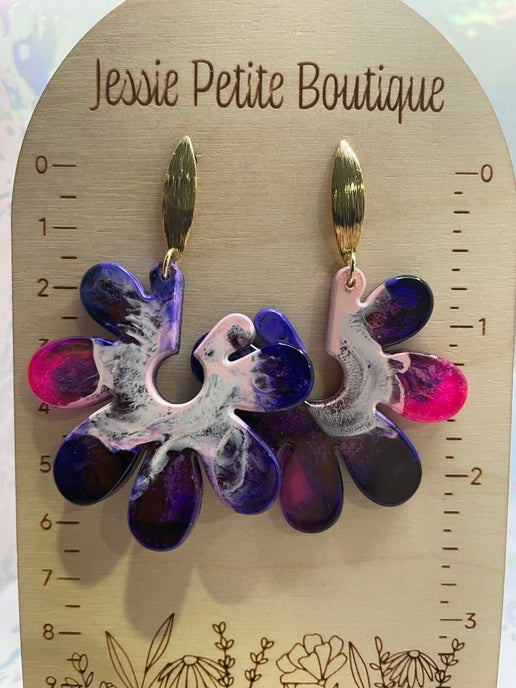 Floral earrings on a wooden display card with 'Jessie Petite Boutique' branding.