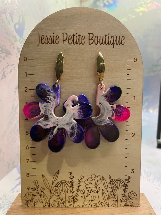 Floral earrings on a wooden display card with 'Jessie Petite Boutique' branding.