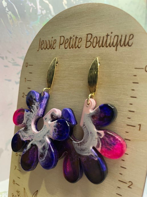 Colorful floral earrings on a wooden display card with 'Jessie Petite Boutique' branding.