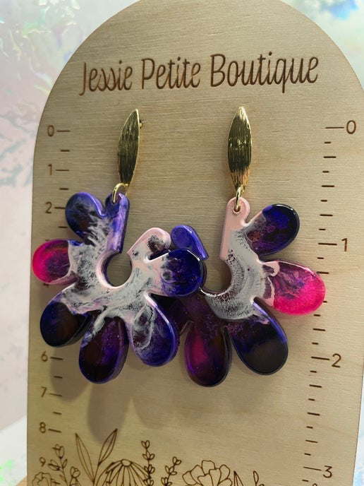 Floral earrings on a wooden card with 'Jessie Petite Boutique' branding