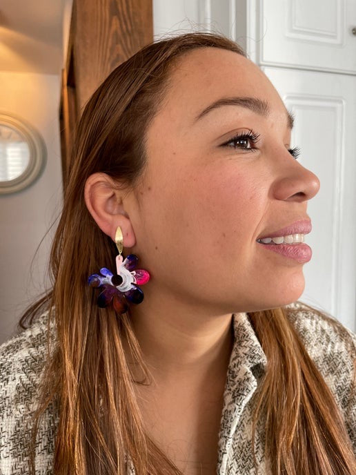 Woman wearing colorful earrings indoors
